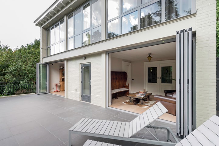 Mit zwei Glas-Faltwänden von Solarlux wird der Wohnraum großzügig zur Terrasse geöffnet.